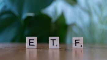 scrabble tiles spelling etf on wooden table
