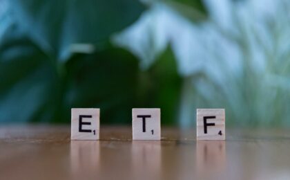 scrabble tiles spelling etf on wooden table